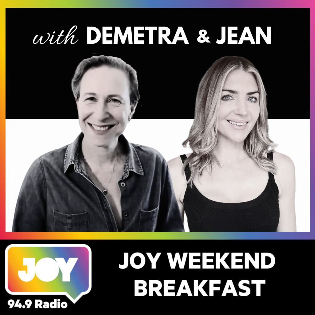 Two women Demetra and Jean facing you are the hosts of JOY radio weekend breakfast show with rainbow coloured border